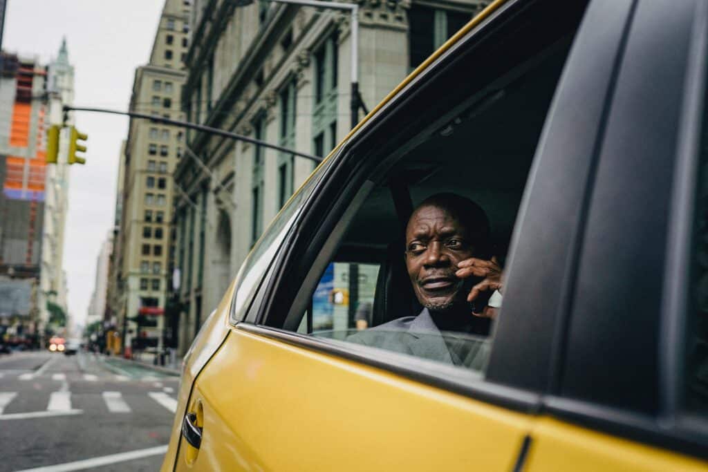 Man going around NYC in a taxi. Source: Pexels.
